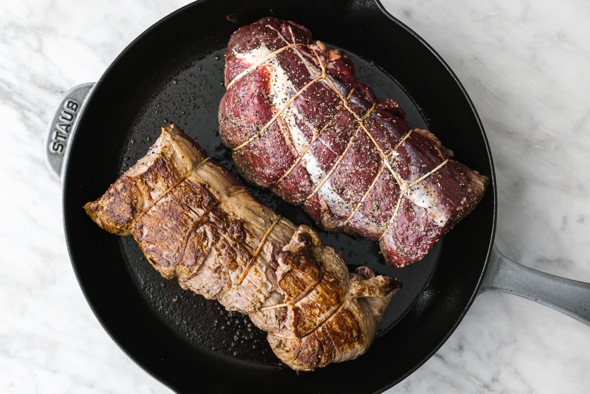 Searing beef tenderloin in a cast iron pan