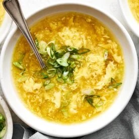 Bowl of egg drop soup and green onion.