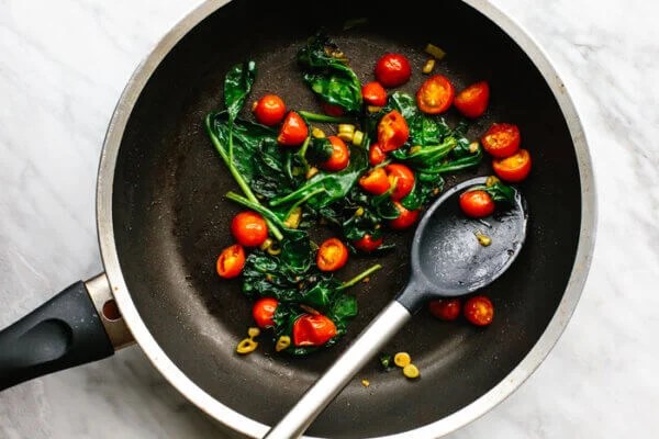 Veggies cooked in a pan for scrambled eggs