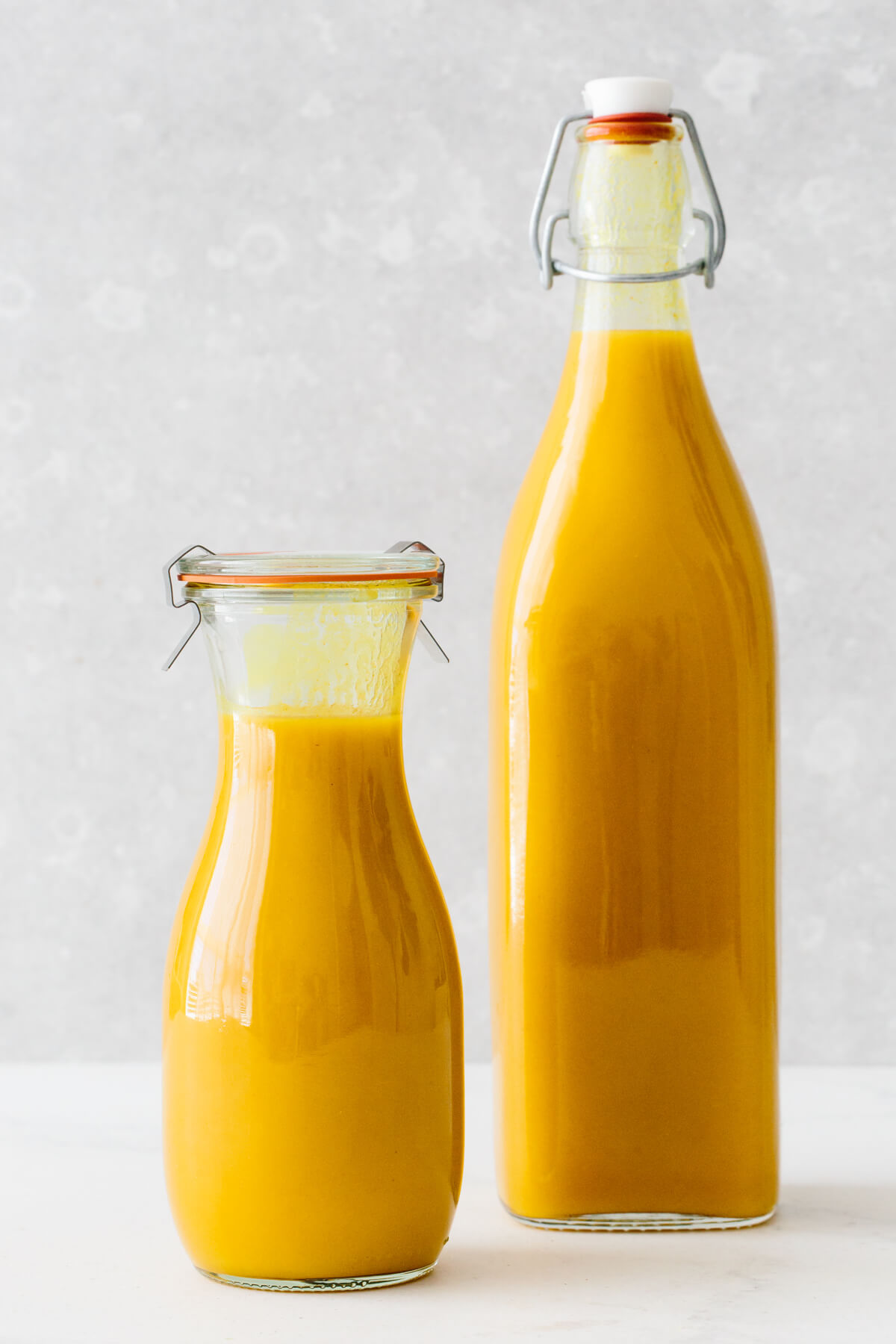 Jamu juice in two glass storage containers.