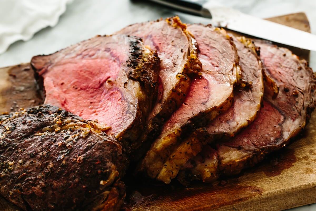Sliced prime rib on a cutting board.