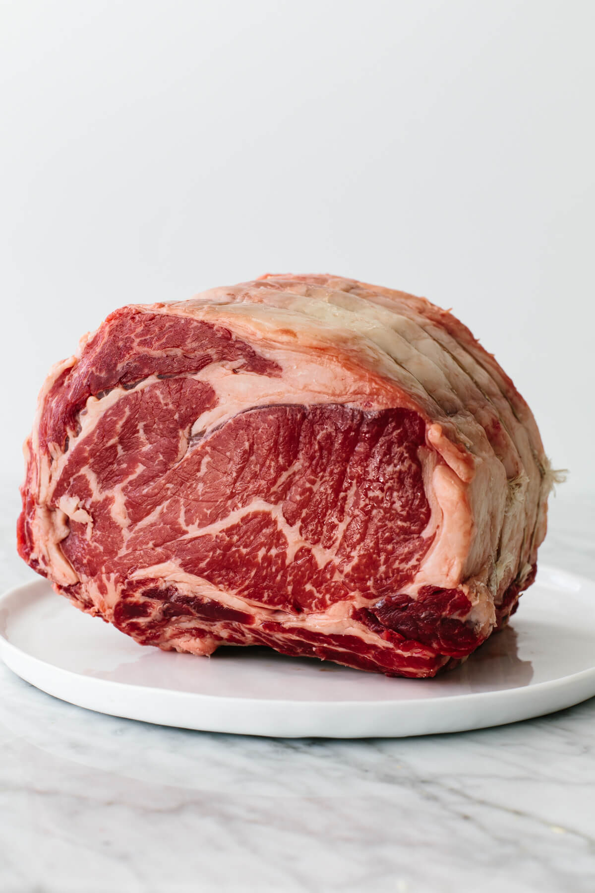 Raw prime rib on a plate.