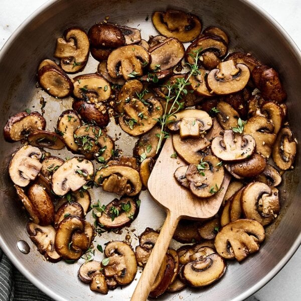 Sauteed mushrooms with thyme in a pan.